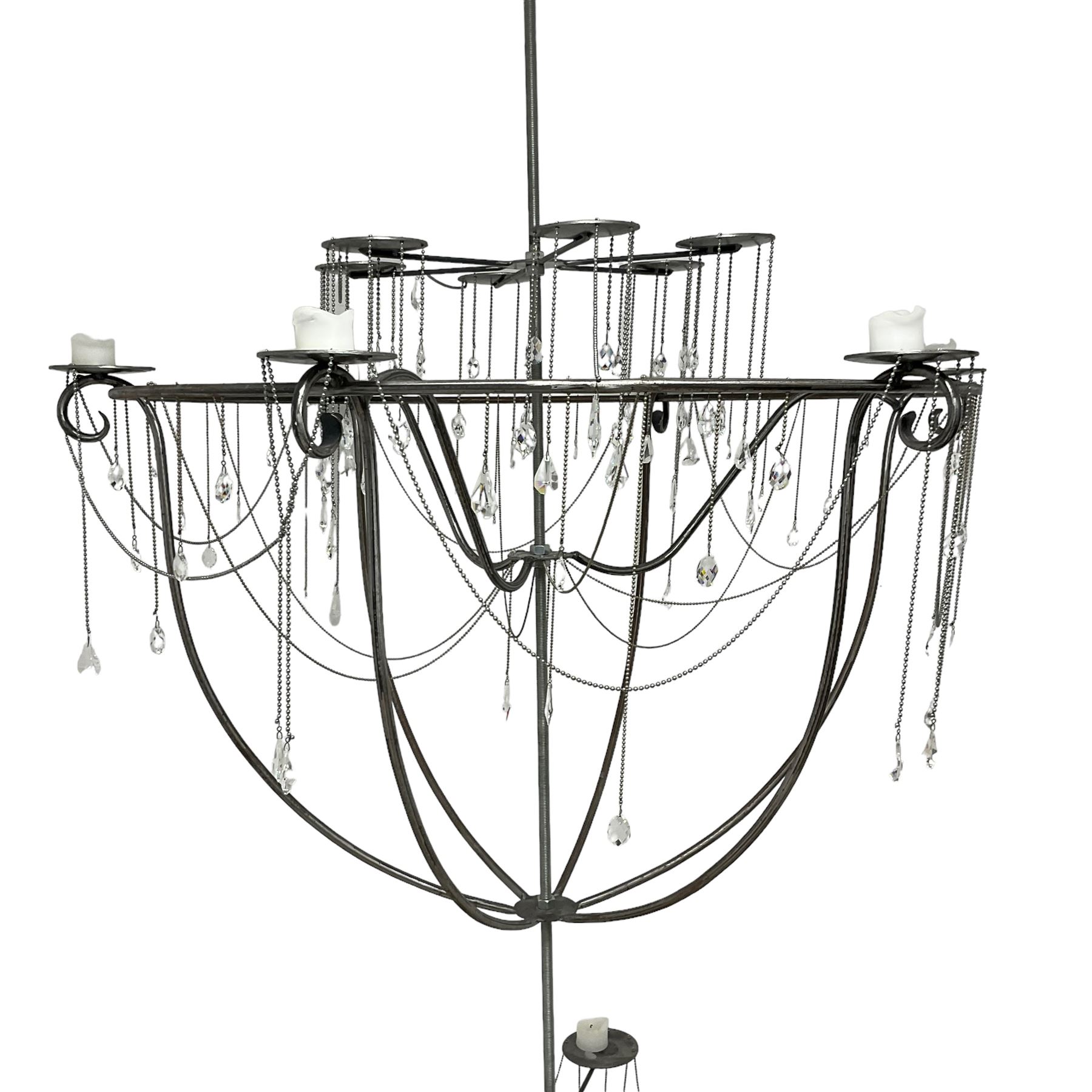 Large bespoke wrought iron cage candle chandelier, the top tier with six extending branches over bell-shape cage with scrolled supports and six branches, six branch lower tier; together with ceiling winch 