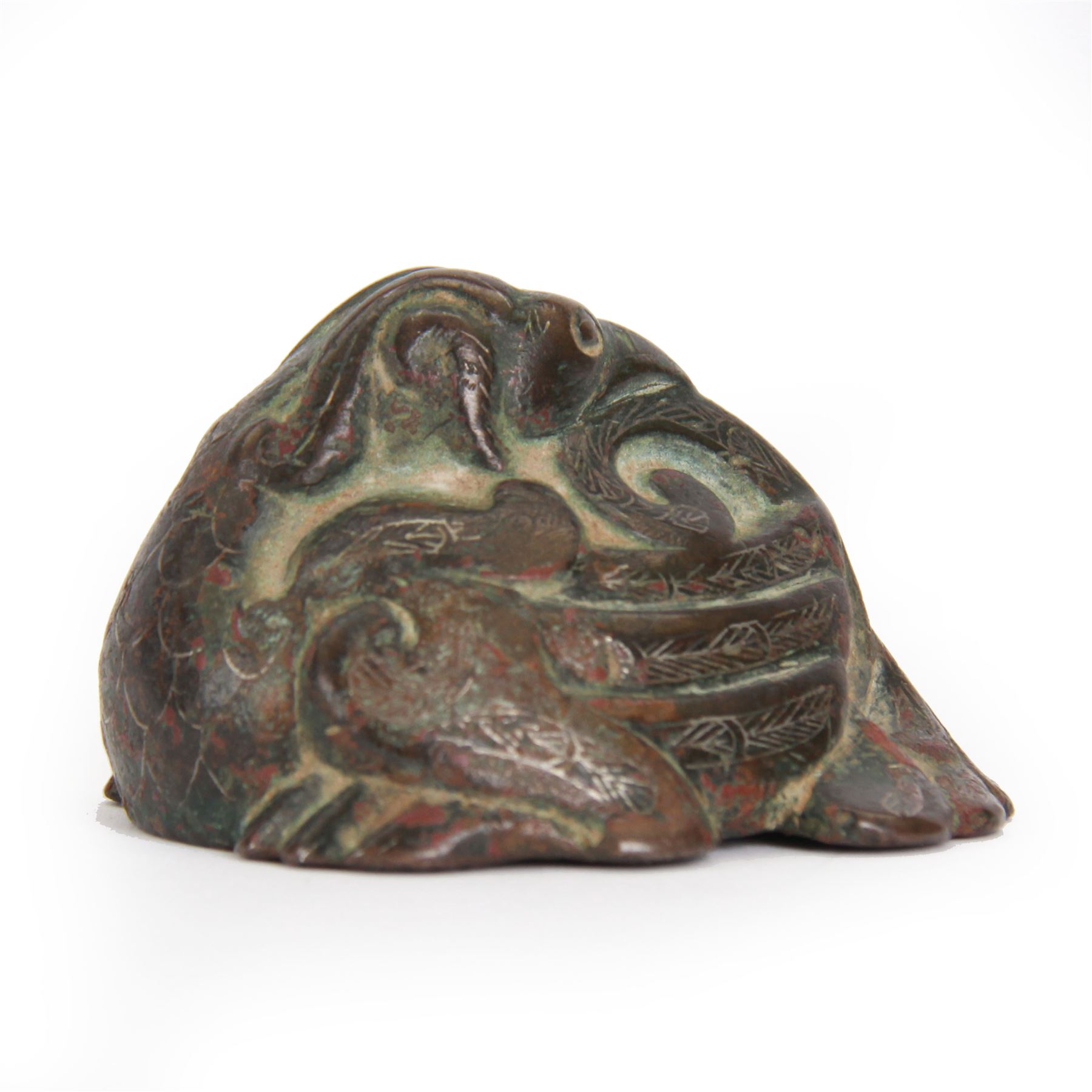 Chinese silver inlaid bronze weight, probably Western Han Dynasty, modelled as a recumbent bird, its head turned and resting upon its back, the details incised with traces of silver inlay, H4cm L6.5cm
