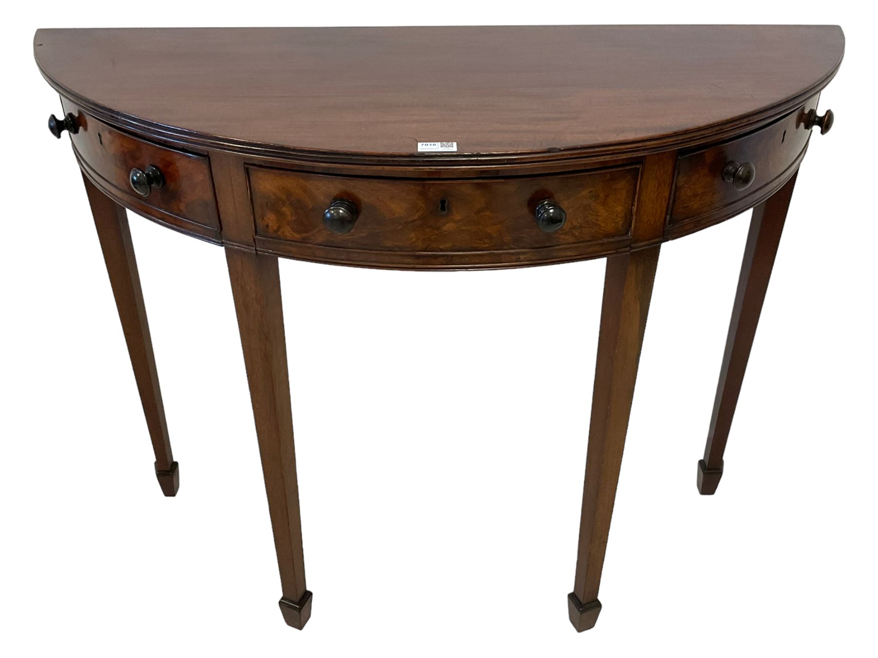 19th century mahogany demi-lune side or console table, reeded edge over central frieze drawer flanked by two hinged drawers with cock-beaded facias and turned handles, raised on square tapering supports with spade feet, the rear supports and feet chamfered in profile