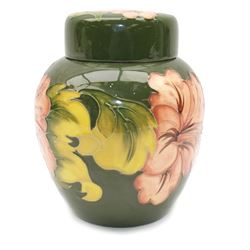 Moorcroft ginger jar in Hibiscus pattern on green ground, with makers mark beneath, H16cm