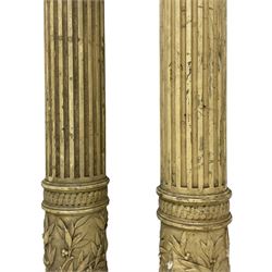 Three 19th century wood and gesso Composite order architectural architraves - curled acanthus leaf capitals over fluted shafts, the bases decorated with guilloche moulding over trailing laurel leaf branches, one half columns, one L-shaped rectangular pilaster and one full column, the largest - H204cm