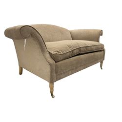 Traditional two seat sofa, curved back over scrolled arms, upholstered in crushed beige fabric with matching loose cushions, on turned front supports with brass and ceramic castors