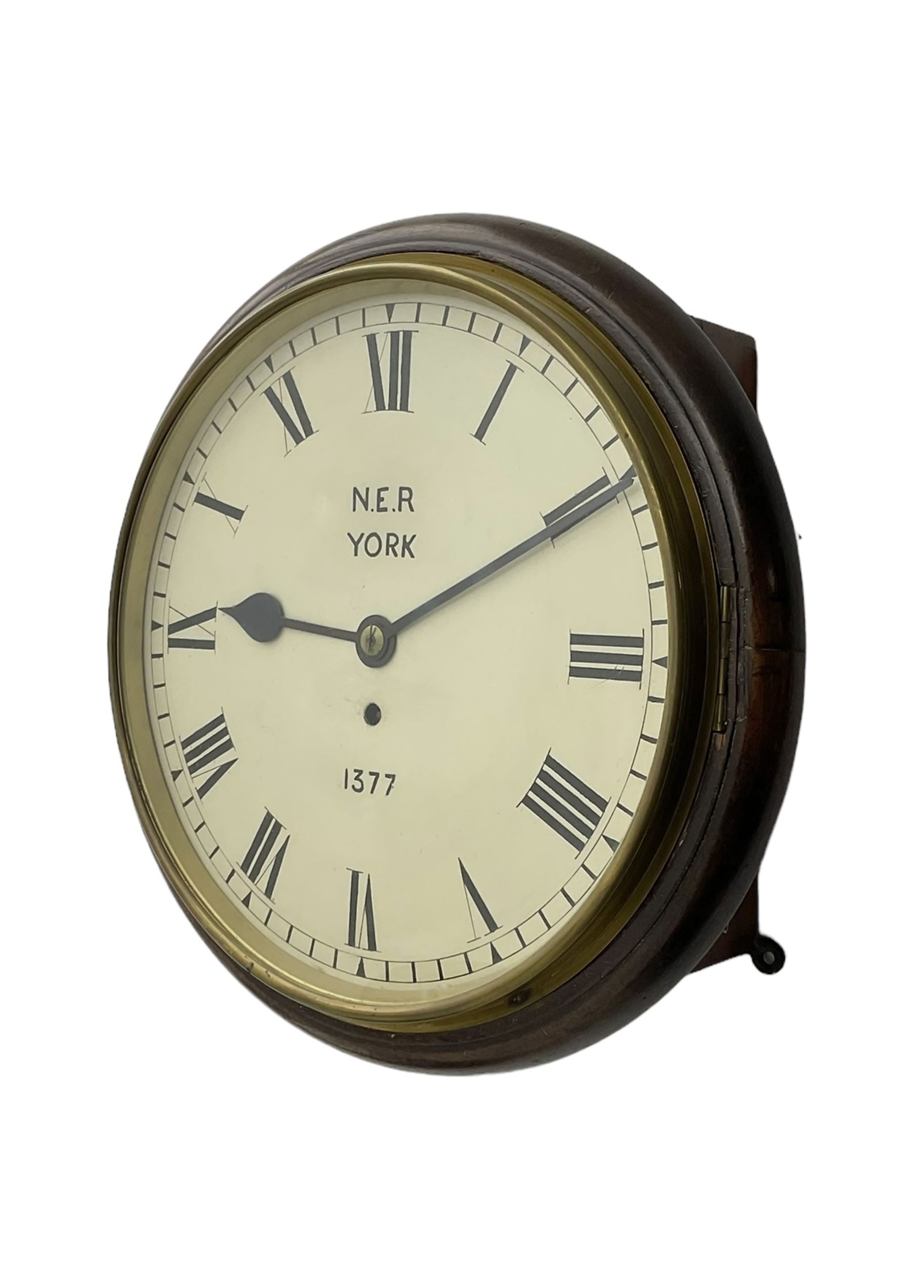 English - 8-day single train Fusee wall clock, with a mahogany dial surround and brass bezel, painted dial with Roman numerals , minute track and steel spade hands, dial inscribed N.E.R. YORK .1377. wire driven fusee with square plates and recoil anchor escapement. With pendulum. 