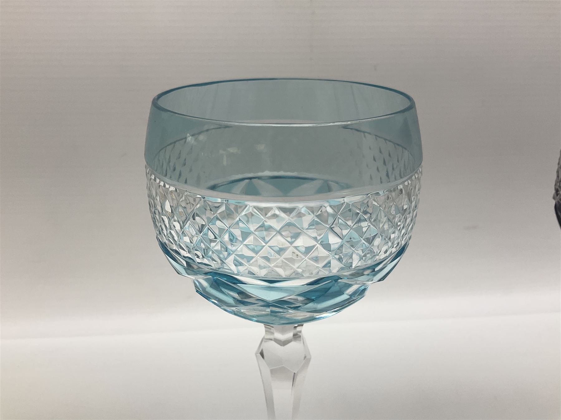 Set of six Harlequin coloured glass hock glasses, each with a band of hobnail decoration, upon faceted stems, H19.5cm