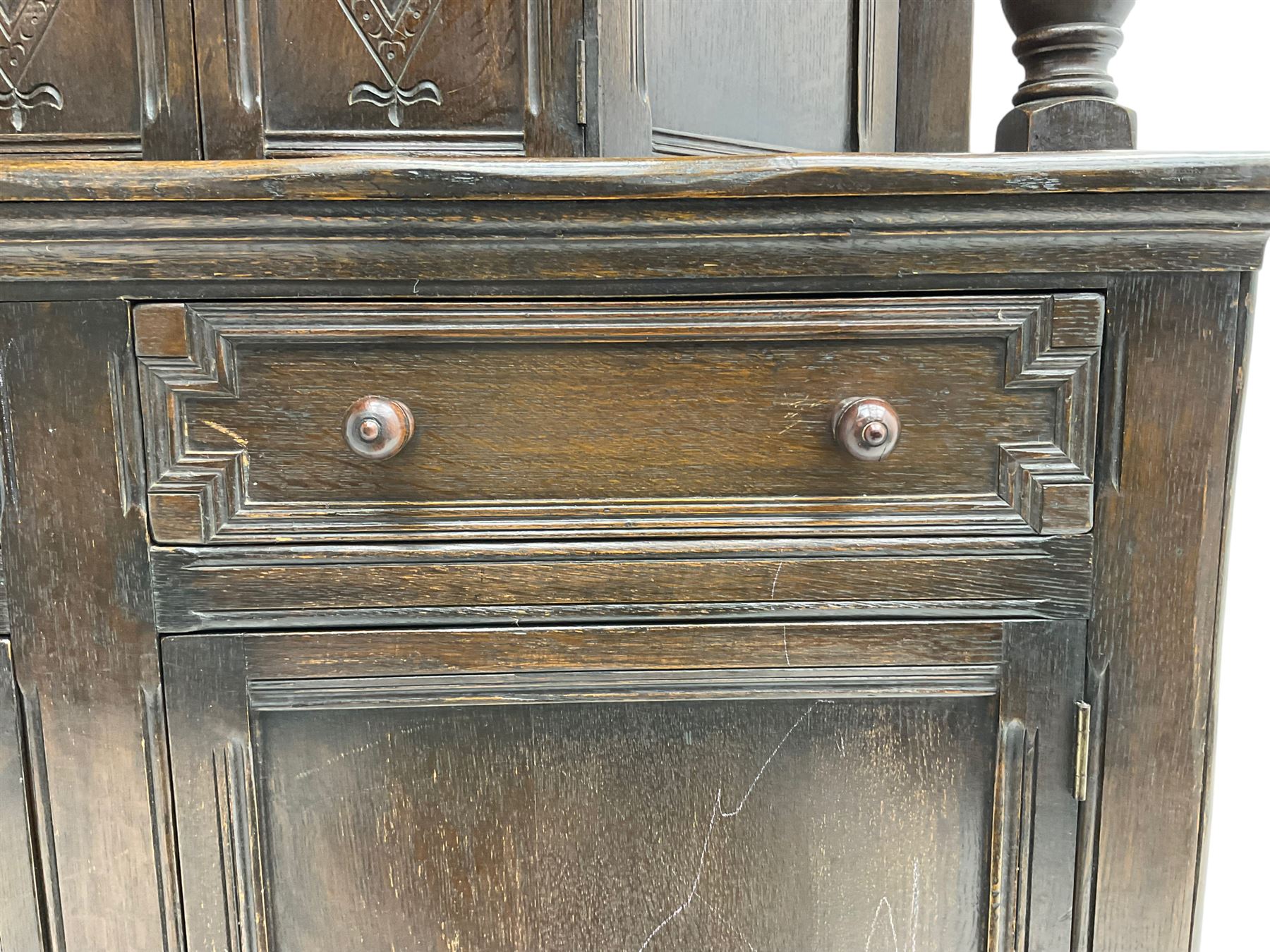 20th century oak court cupboard, arcade carved frieze over baluster supports with demi-hexagon cupboard with lozenge carved facias, the base fitted with two drawers over double cupboard, each with heavily moulded edges