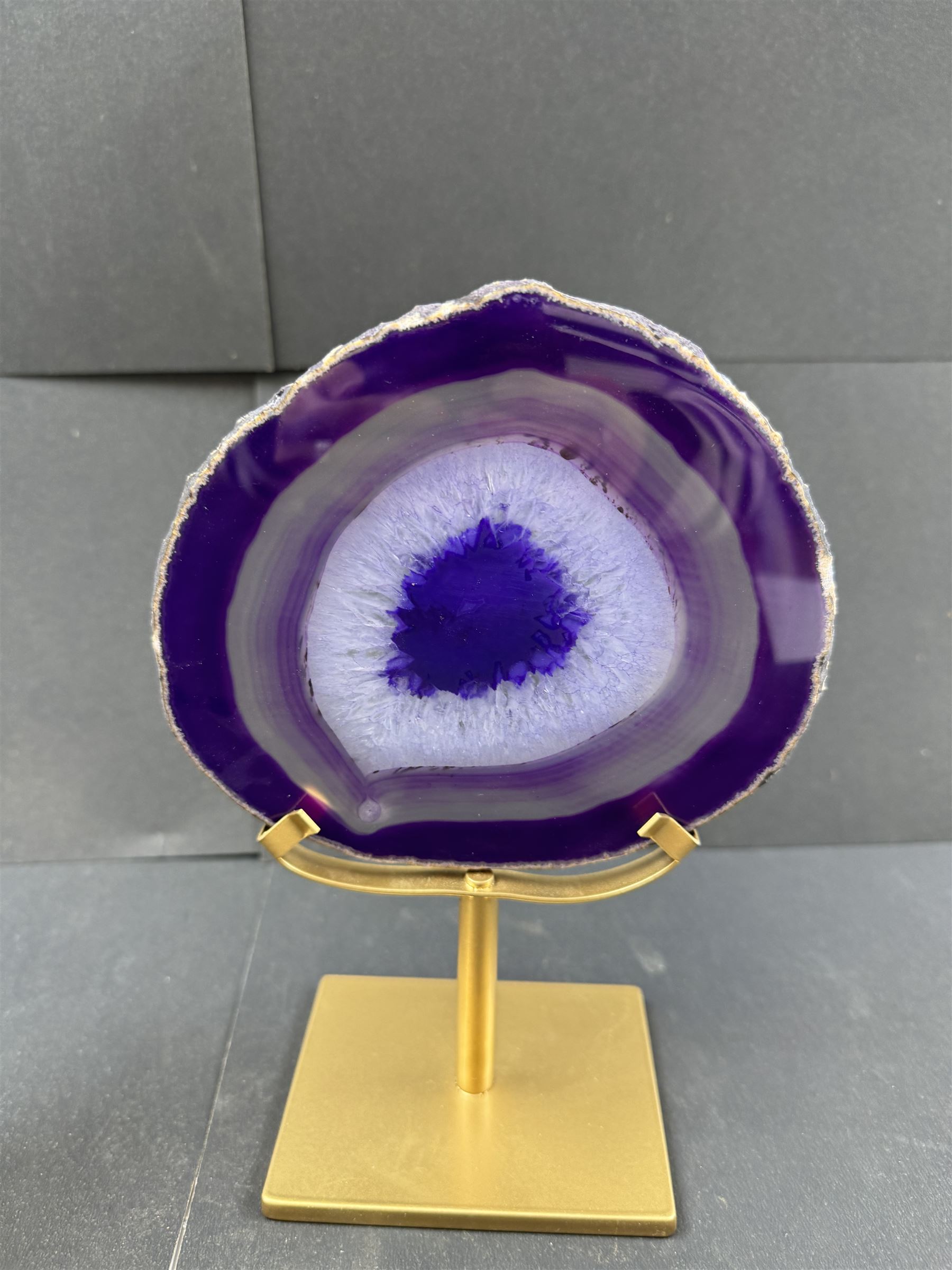 Pair of purple agate slices, polished with rough edges, raised upon gilt metal stands, H22cm