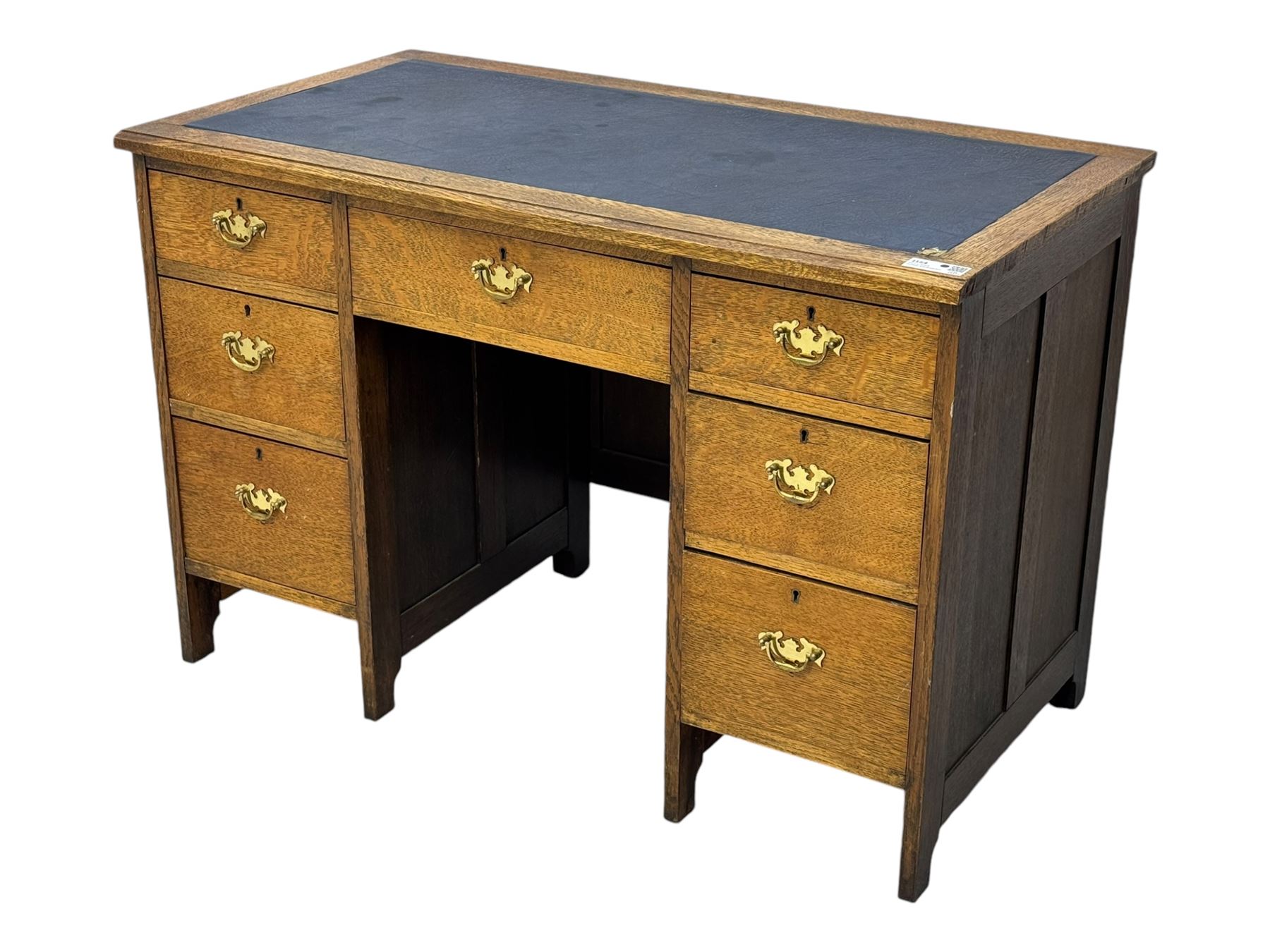 Edwardian oak twin pedestal desk, moulded rectangular top with inset writing surface, fitted with seven drawers, panelled sides, on stile supports 