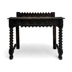 Victorian Gothic revival style carved oak console table, rectangular top with carved edge and raised back gallery, over deeply carved apron with floral and foliate motifs and central drawer, barley twist front supports and plain rear supports united by shaped stretchers, on front bun feet