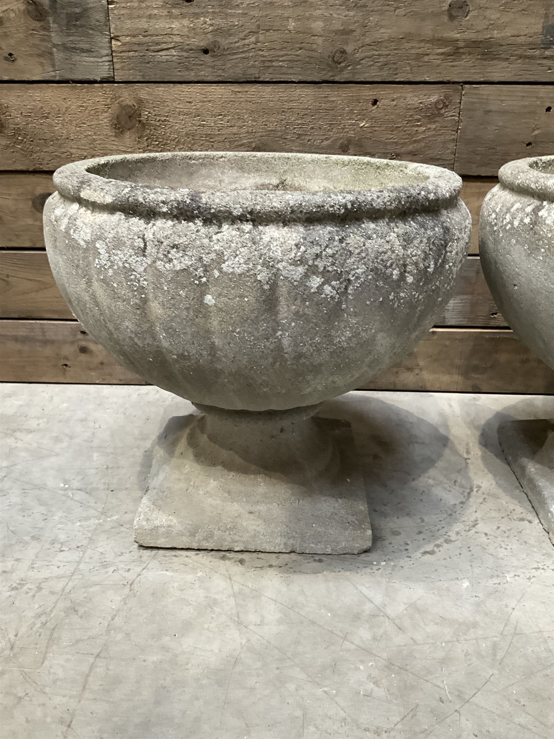 Pair of circular cast stone circular planters, and a similar pair decorated with swags (4)