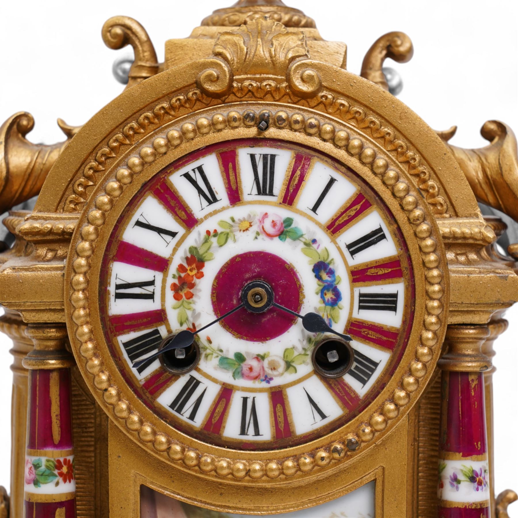 French - Late 19th century 8-day gilt metal and porcelain mounted clock c1880, the arched case above a plinth base on paw feet surmounted by an urn, porcelain dial with cartouche Roman numerals and steel spade hands, twin train rack striking movement, sounding the hours and half hours on a bell. With pendulum. 