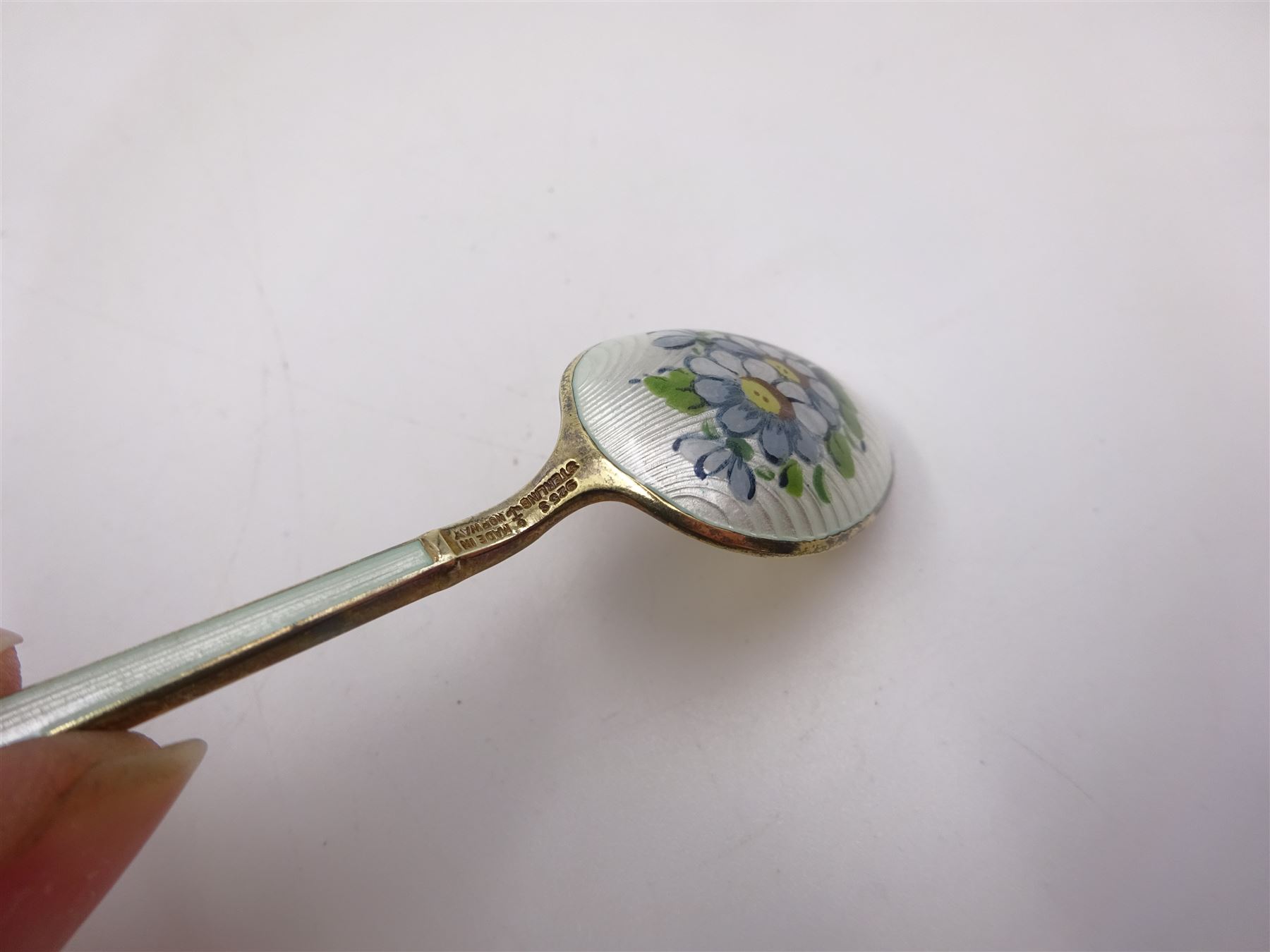 Set of six Norwegian silver-gilt and enamel demitasse spoons, decorated front and verso with small colourful flowers on a white ground,  925S Sterling, in retailers box for Magnus Aase, Bergen