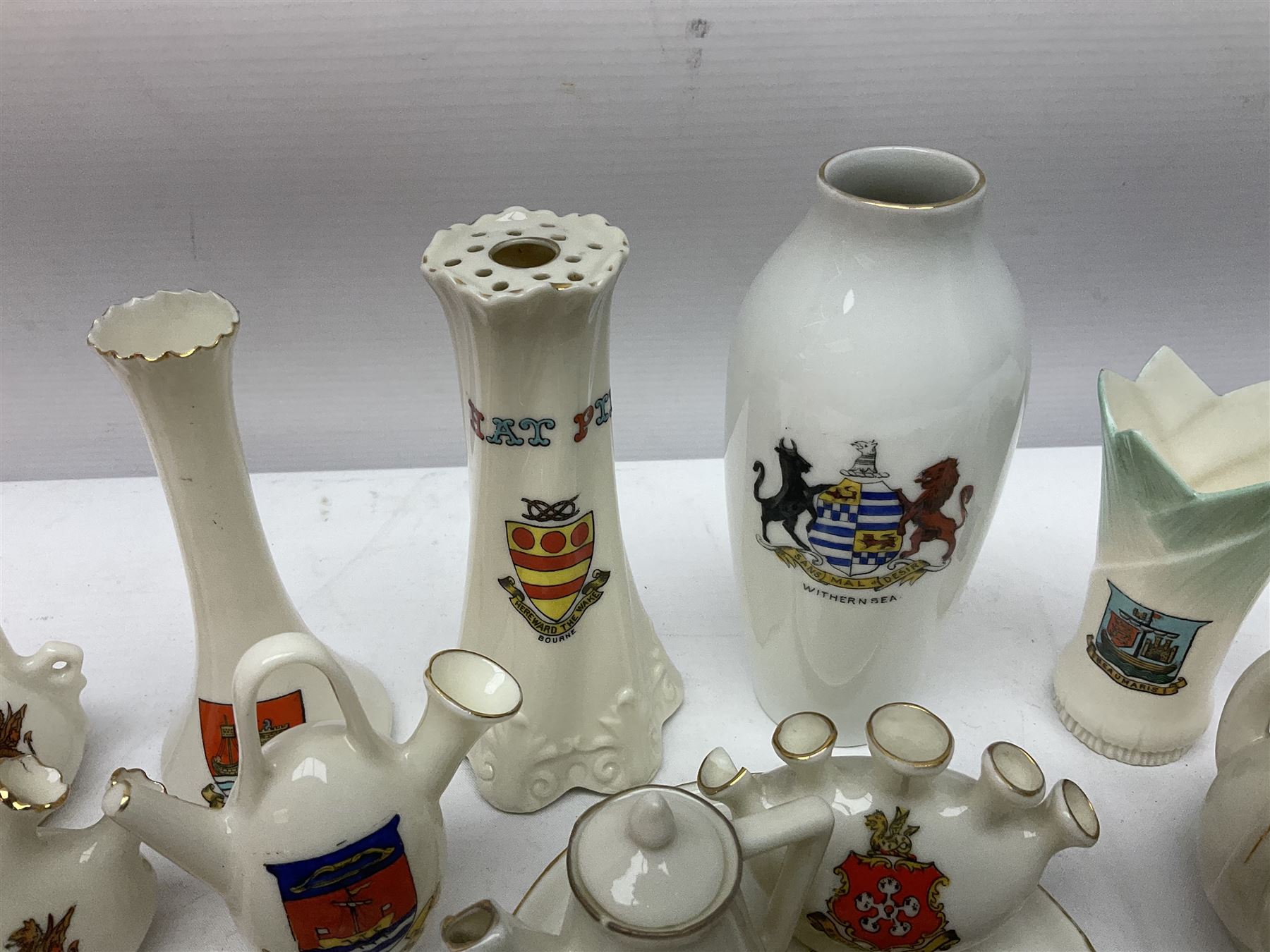 Collection of crested ware, including vases, hat pin stand, miniature teapot etc 