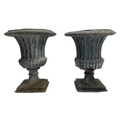 Pair of 19th century lead Campana shaped garden urns, egg and dart moulded rim, tapered fluted body over gadrooned underbelly, tapered and fluted foot on moulded square base 