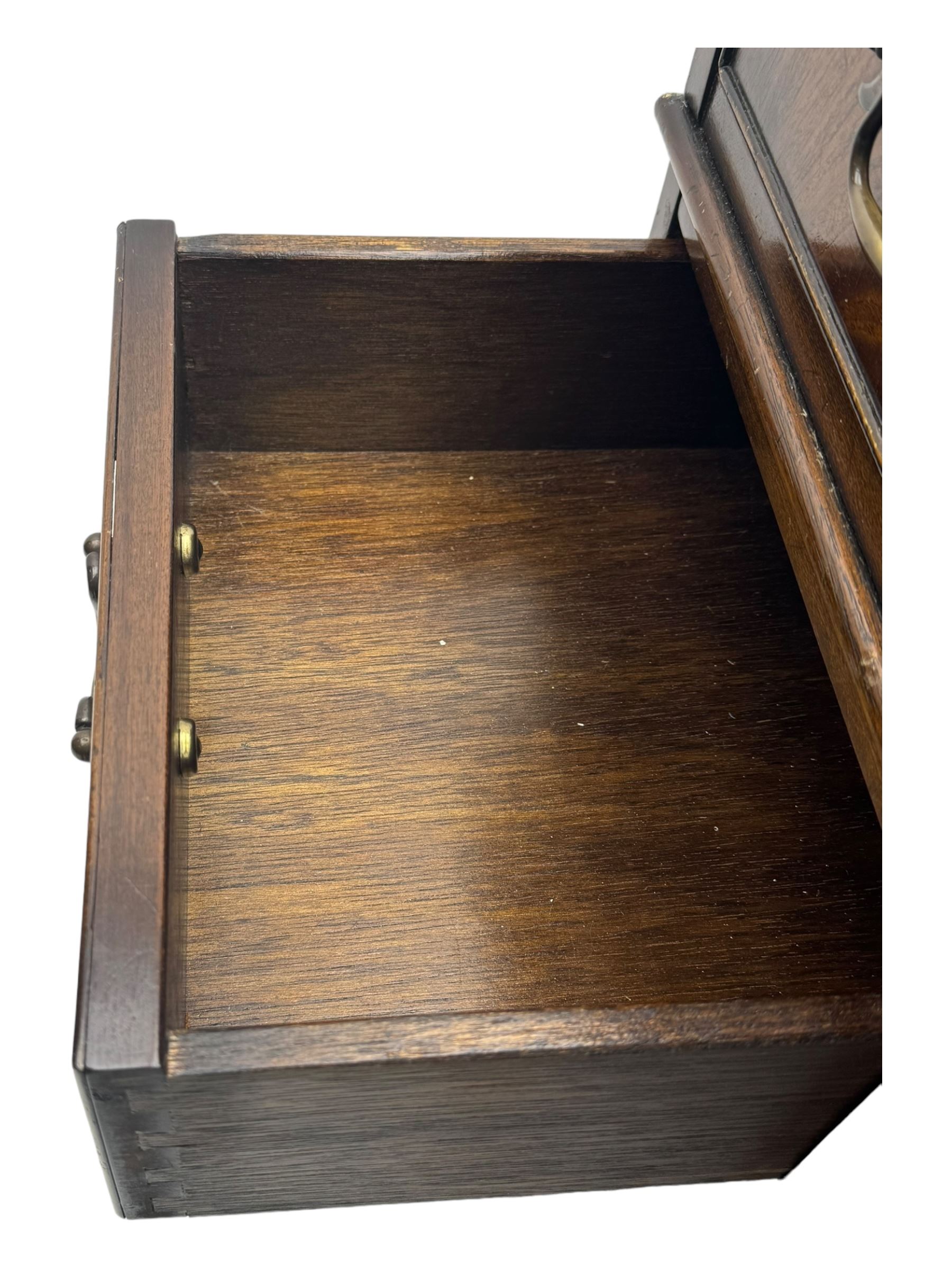 20th century mahogany twin pedestal desk, moulded rectangular top with red leather inset with gilt tooled border, central drawer over kneehole flanked by two banks of four graduating cockbeaded drawers, on plinth base