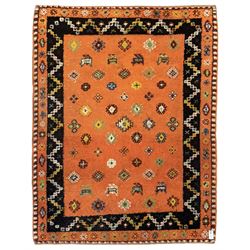 Moroccan amber ground thick pile rug, the field decorated with stylised geometric lozenges and camel motifs, the guard bands with stylised foliate and plant motifs