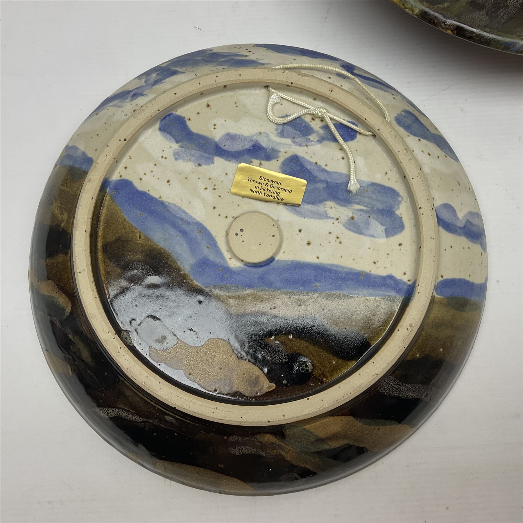 Wendy Abbott Salt; Three studio pottery dishes, decorated in High moorland pattern, largest D34cm 