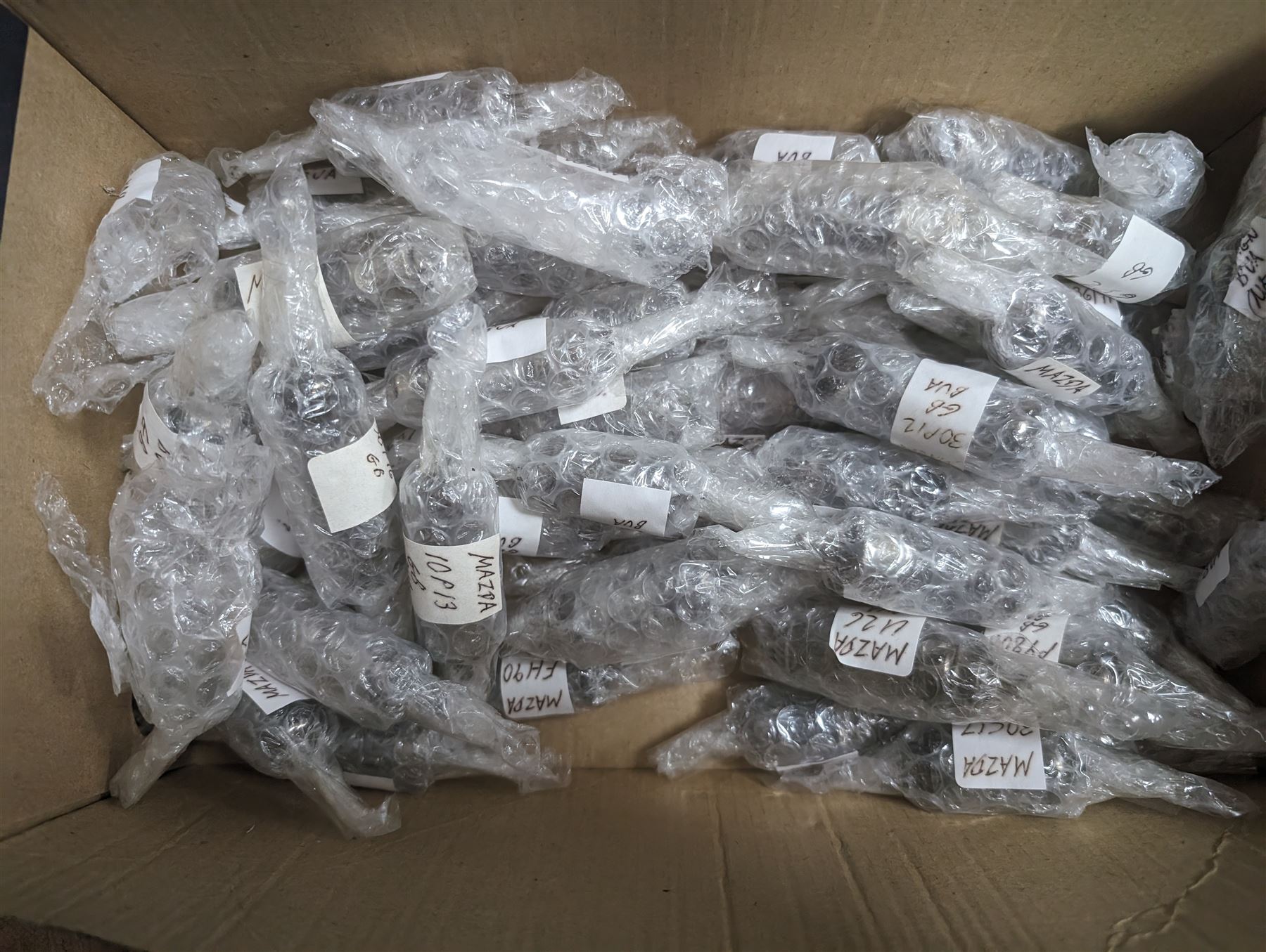 Large collection of Mazda thermionic radio valves/vacuum tubes, including boxed examples and loose bubble wrapped and identified examples