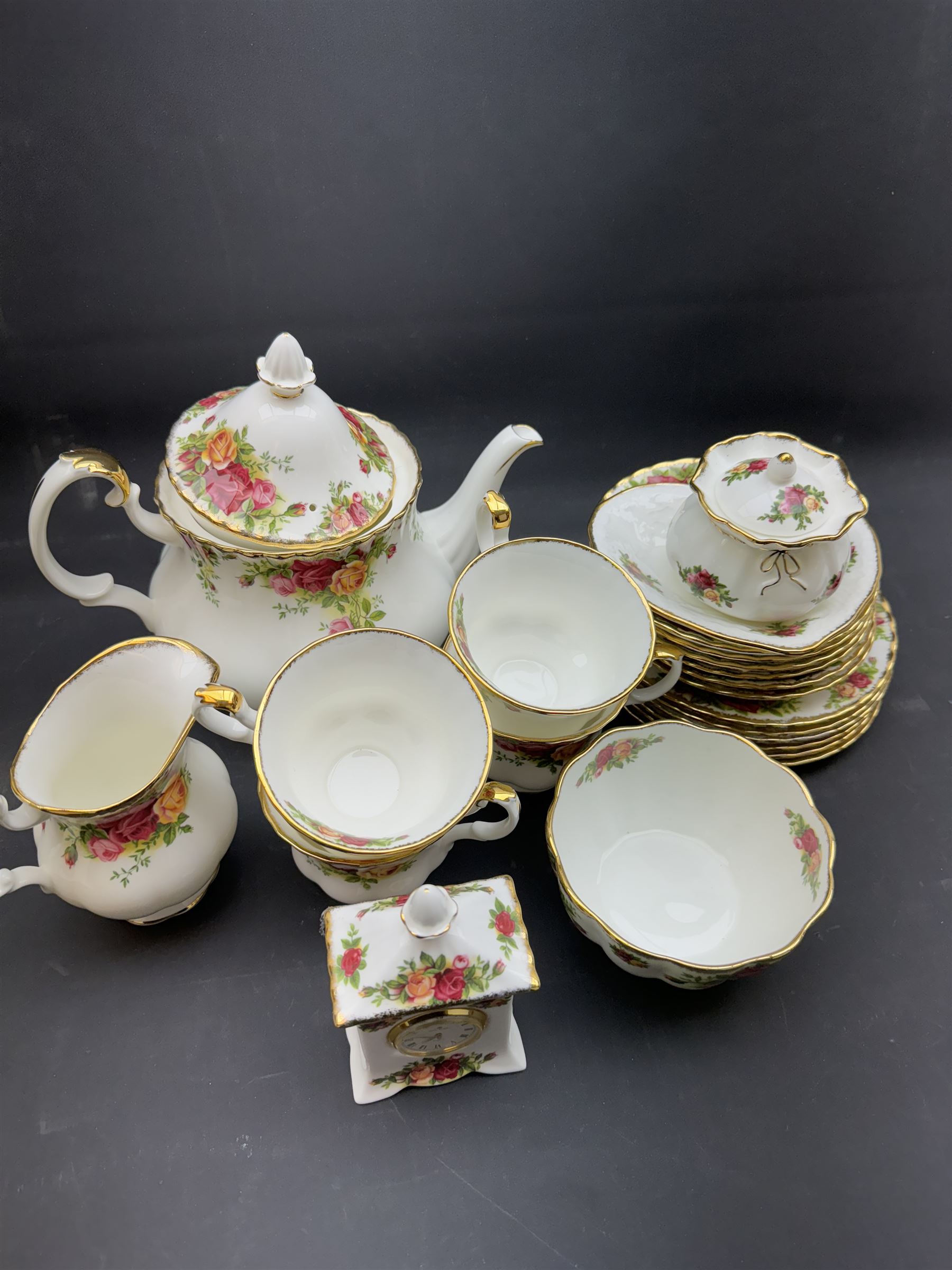 Royal Albert Old Country Roses tea service for six, comprising teapot, milk jug, open sucrier, cups and saucers, dessert plates, two trinket dishes covered jar and clock