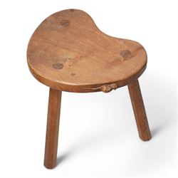 Mouseman - oak kidney-shaped stool, on three tapered octagonal supports, carved with moues signature, by the workshop of Robert Thompson, Kilburn 