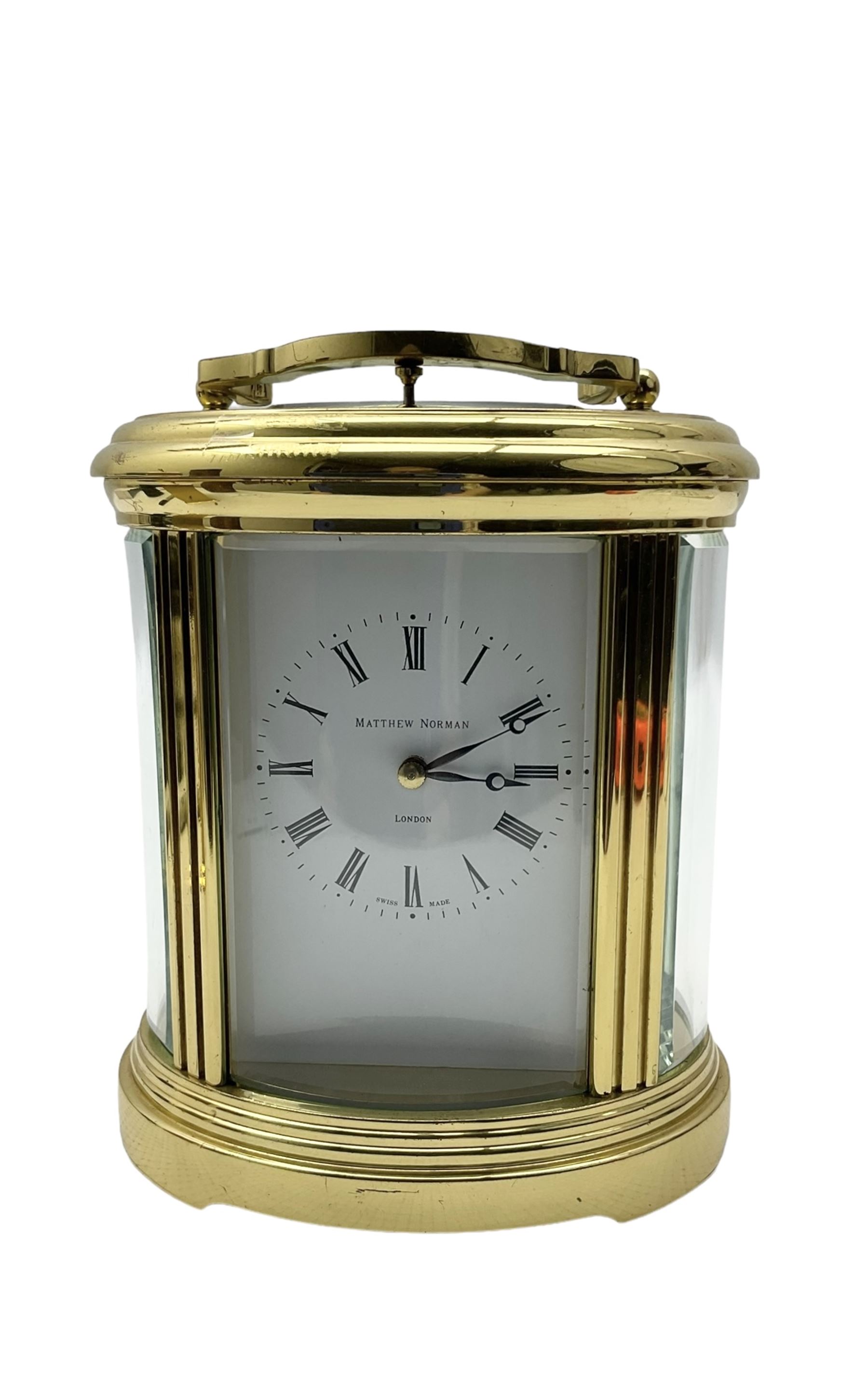 Matthew Norman - 20th century 8-day oval cased carriage clock, enamel dial with Roman numerals and minute markers, twin train rack striking movement with a lever platform escapement and repeat function, striking the hours and half hours on a coiled gong, with key.