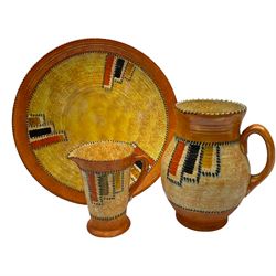 1930s Crown Ducal ceramics, designed by Charlotte Rhead, each in the 3274 Stitch pattern, comprising charger, jug and large jug, large jug H21cm 