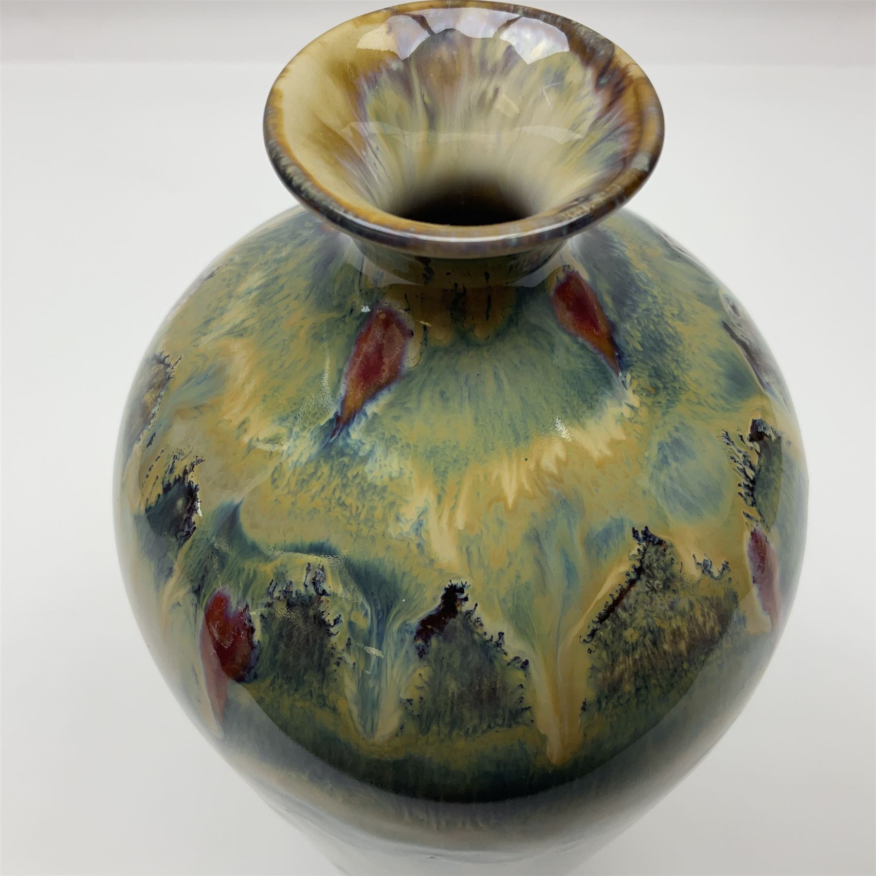 Cobridge Stoneware vase of bluster form by Andrew Hill, decorated in layered dripping blue red and brown glaze, with impressed and painted mark beneath 