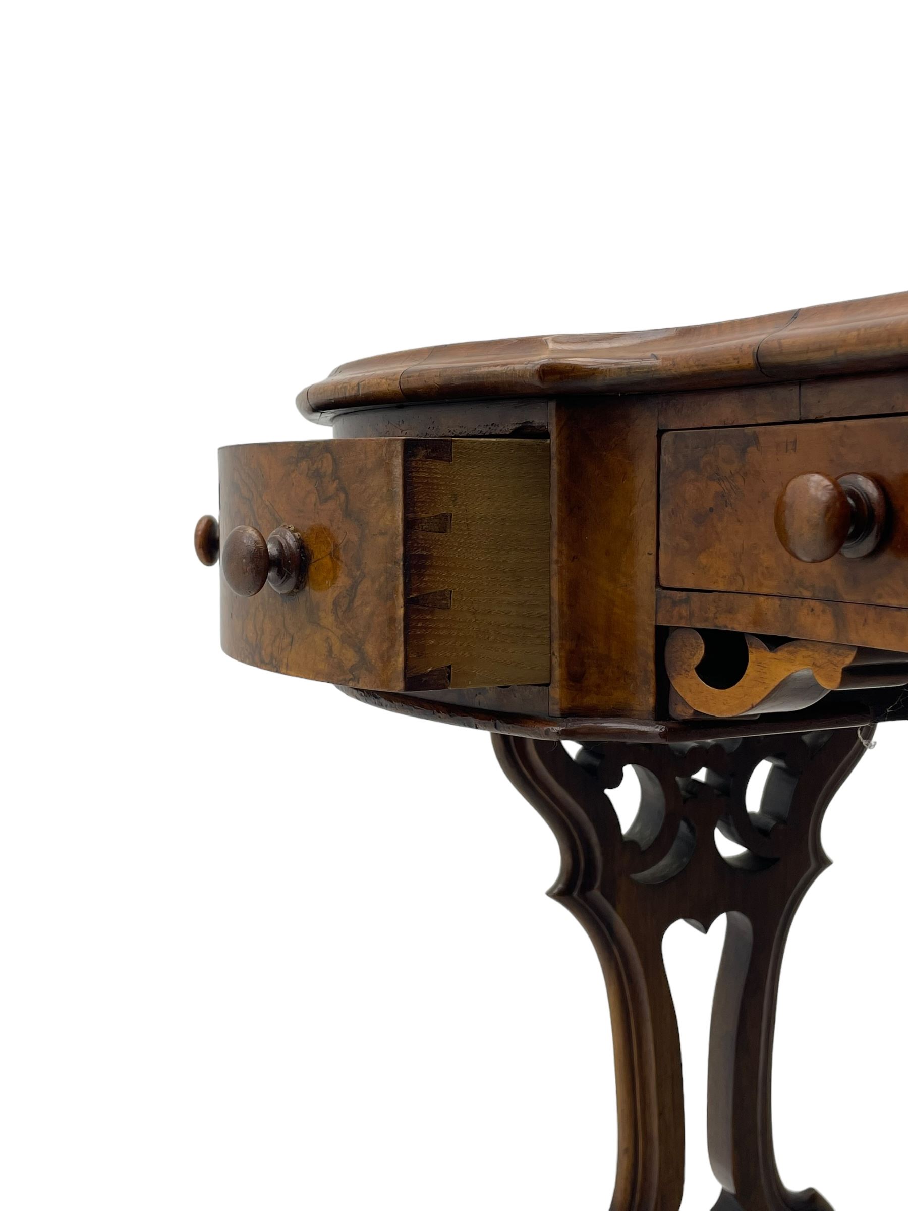 Victorian walnut kidney-shaped writing desk, moulded top with floral cast brass gallery and inset leather writing surface, fitted with three frieze drawers with turned handles, shaped and pierced end supports on raised platforms terminating to splayed feet, united by twist turned and lobe carved stretcher, brass and ceramic castors 