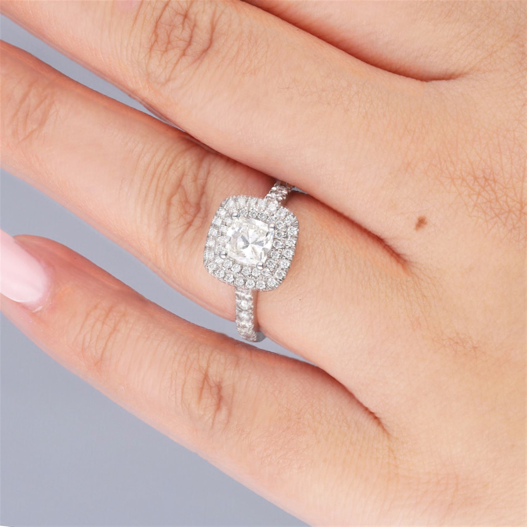 Platinum diamond halo cluster ring, the principal cushion cut diamond of 1.00 carat, with round brilliant cut diamond surround and diamond set shoulders, hallmarked, total diamond weight approx 1.45 carat