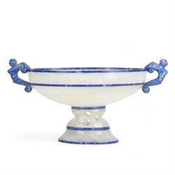 Lapis lazuli and agate twin handled pedestal bowl of navette form, the handles carved as harpies, upon a pierced oval pedestal, 19cm