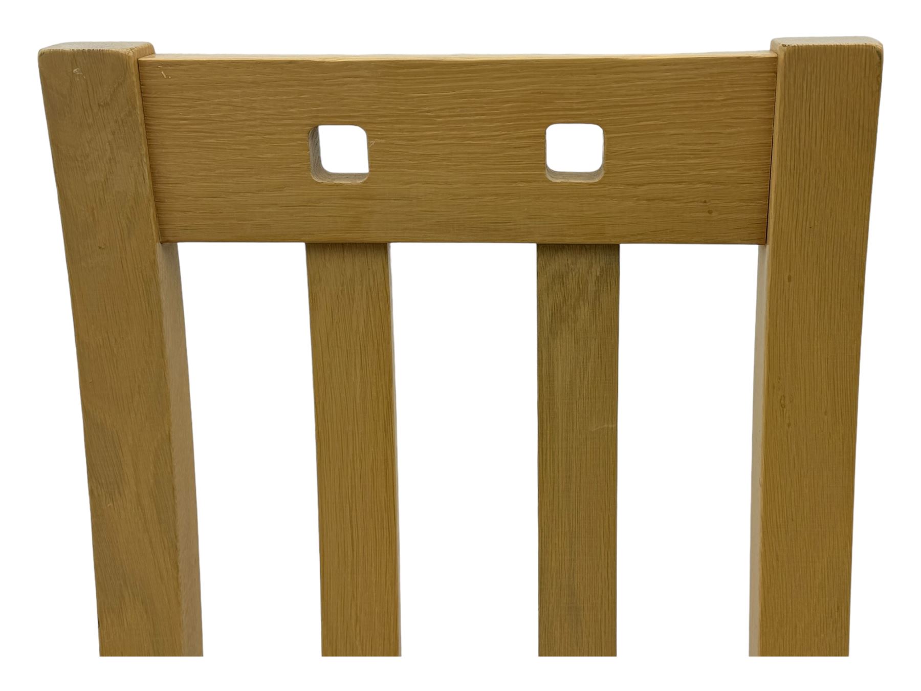 Contemporary set of four oak dining chairs, tall slatted curved backs with square cutouts to the top, upholstered seats in light fabric, on square front supports