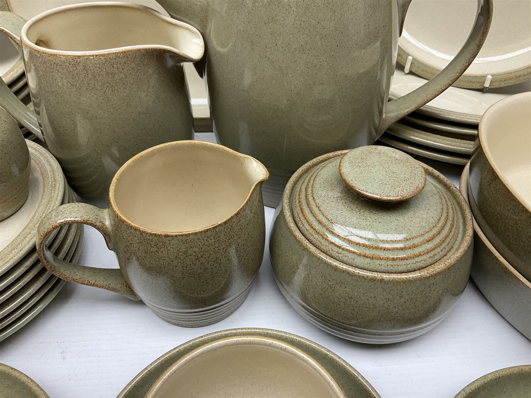 Denby tea and dinner wares, including bowls, jugs, tureens, side plates, dinner plates, serving dishes, cups and saucers, coffee pot, etc, all decorated with a green and brown mottled glaze, with printed marks beneath, in two boxes 