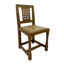 Rabbitman - set of six (5+1) oak dining chairs, pierced and carved lattice back, leather upholstered seat with stud band, on octagonal supports united by stretchers, carved with rabbit signature, by Peter Heap of Wetwang 