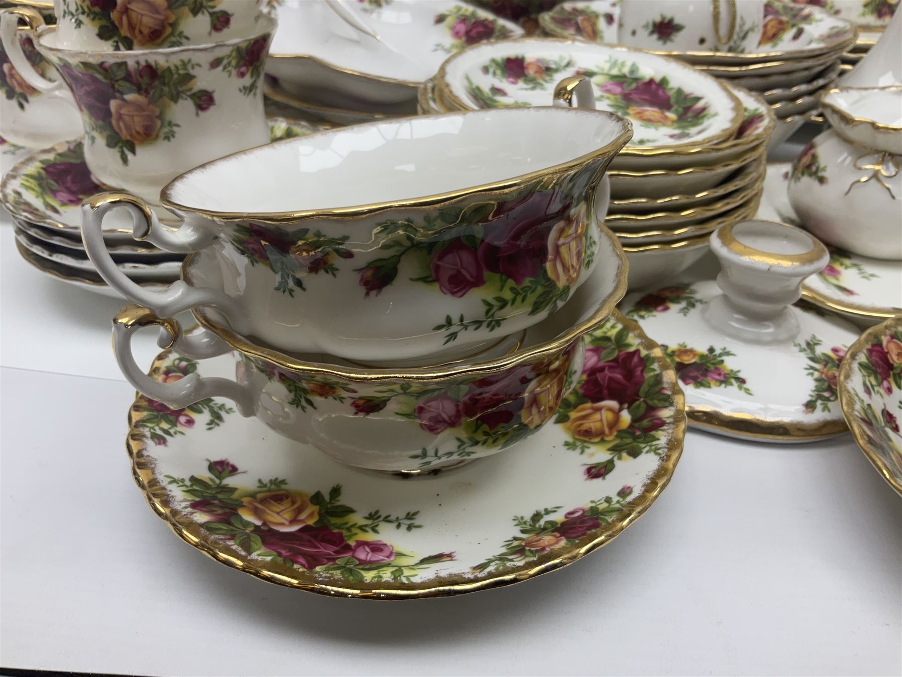 Royal Albert Old Country Roses pattern part tea and dinner service, to include two tureens, eight dinner plates, six side plates, twelve bowls, two mugs, seven teacups and saucers, milk jug,  twelve cake plates, six soup bowls and saucers, candlesticks, etc (95)