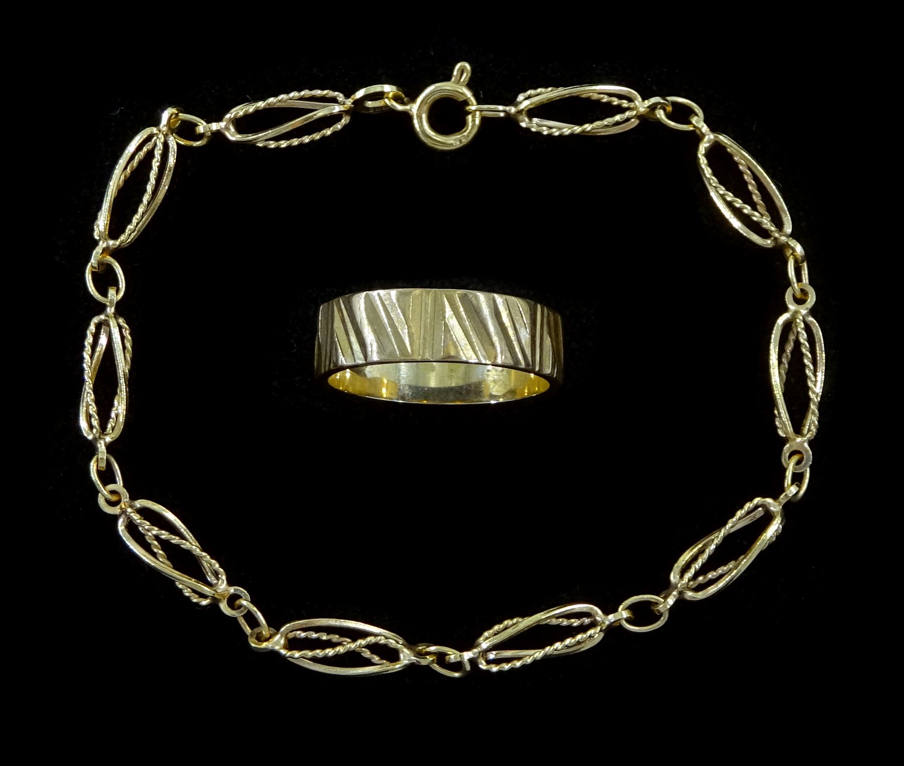 Gold fancy openwork twist link bracelet and a gold wedding band, both hallmarked 9ct