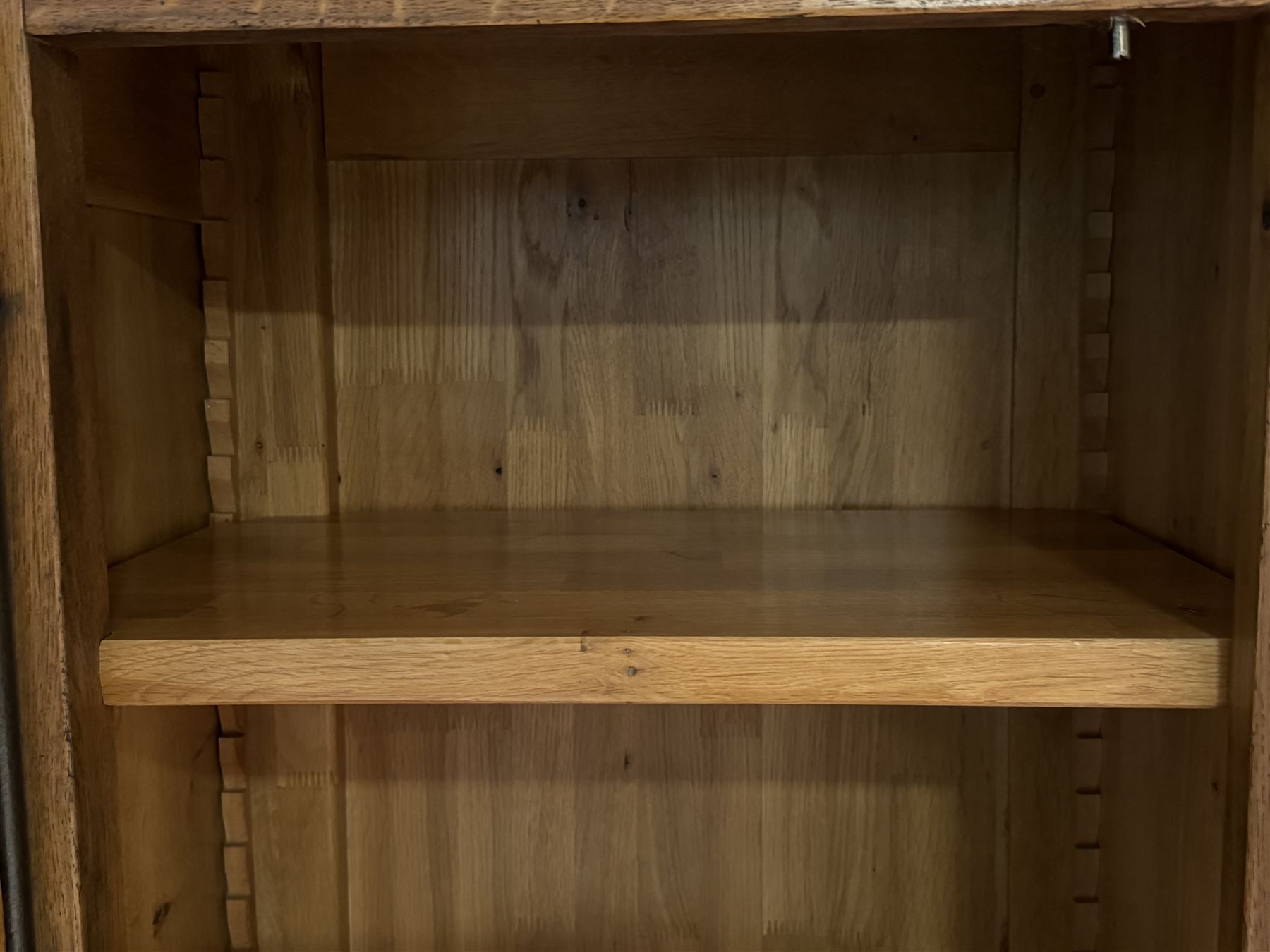 Large 20th century oak dresser, projecting cornice over open arched central section with two shelves, flanked by two panelled cupboards with two shelves, lower section with three drawers above three cupboards, on stile supports 