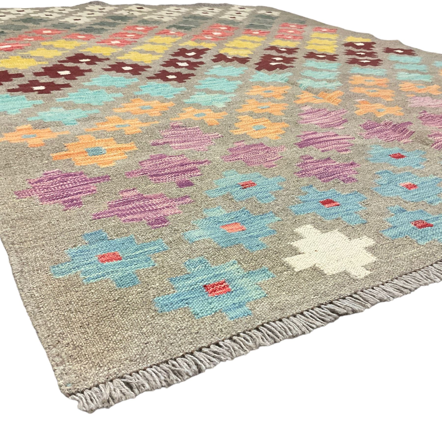 Anatolian Turkish kilim, light grey ground and decorated with multi-coloured geometric star motifs