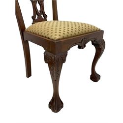 Set of twelve Chippendale design mahogany dining chairs, shaped cresting rail carved with foliage and C-scrolls, pierced interlaced splat with curled leaf decoration, upholstered drop-in seat, moulded seat rails, on scrolled acanthus carved cabriole supports with ball and claw feet 