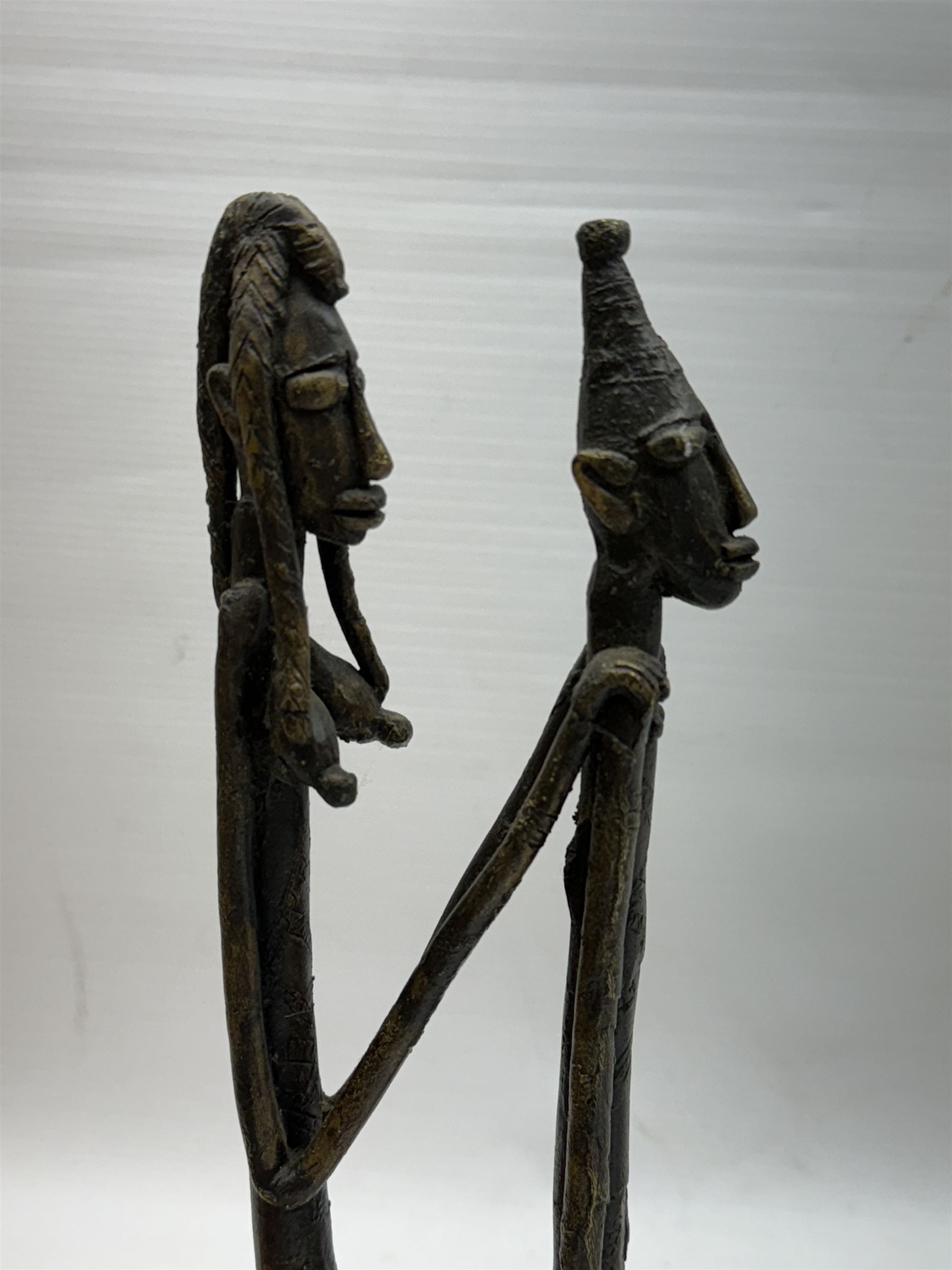 Five bronzed tribal figures, of elongated form, tallest H18cm