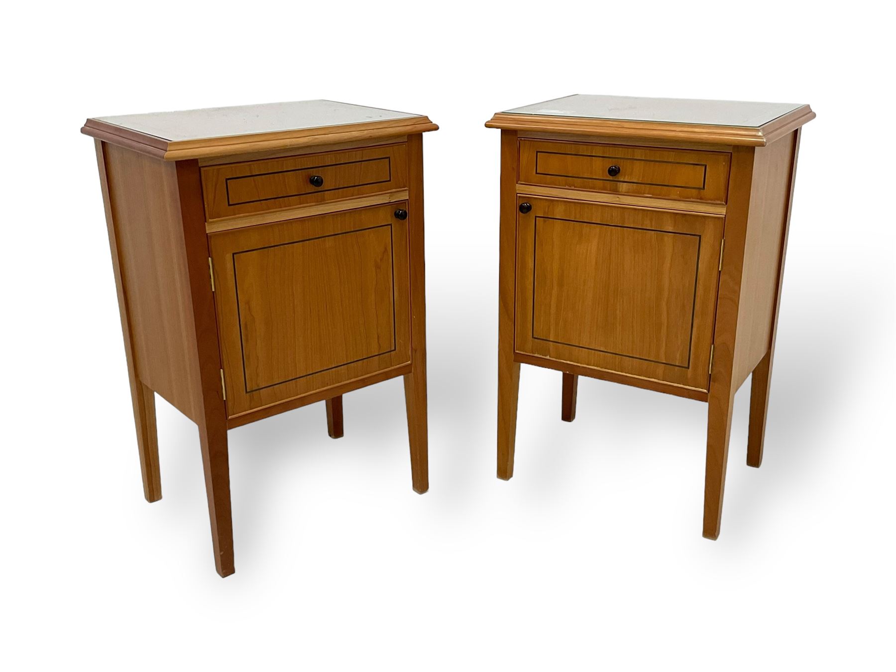 Pair of contemporary cherry wood bedside cupboards, inset glass top in moulded frame, fitted with single drawer over cupboard, on square tapering supports 