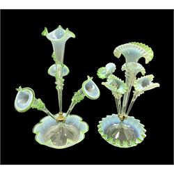 Two Victorian green Vaseline glass epergnes, the first example with three trumpet shaped b...