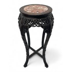 Early 20th century Chinese hardwood plant stand, circular top with marble inset, carved and pierced with interlacing foliage, on leaf carved supports united by x-framed stretchers