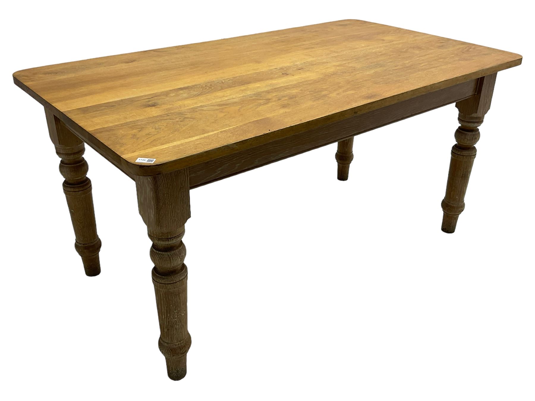 Limed oak dining table, rectangular top with rounded corners, on turned supports