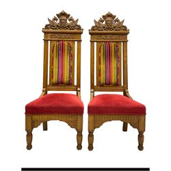 Set of six 20th century Carolean design oak high back chairs, the pediment carved with dragons and central Green Man mask with trailing foliage, the backs upholstered in striped fabric, on turned front supports