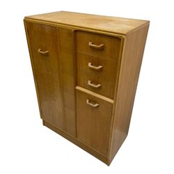 G-Plan - mid 20th century teak tallboy or combination wardrobe, left side with full-height hanging cupboard, right side with three drawers, the top fitted with vanity mirror, above cupboard with shelves, raised on a plinth base