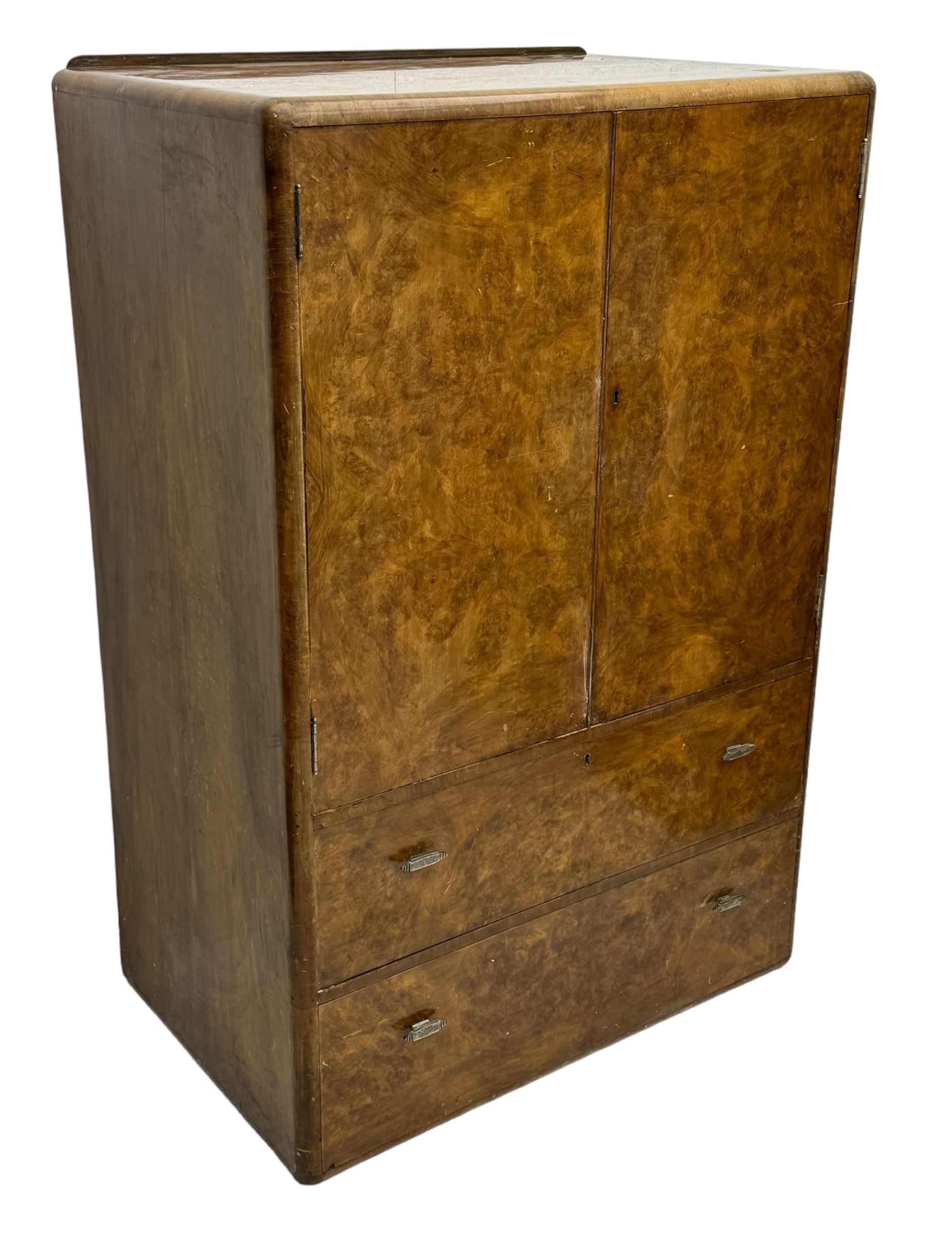 Early 20th century burr walnut cabinet, rectangular top with raised back, over double-door cupboard enclosing camphor interior with single shelf, lower section fitted with two drawers