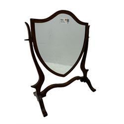 Edwardian mahogany shield-shaped dressing mirror, shaped frame with swivel function, on scroll supports connected by curved stretcher 