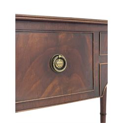 George III mahogany kneehole dressing or writing table, stepped bow-front form, reed moulded top with mahogany crossband, fitted with three cock-beaded drawers with circular pressed brass handle plates decorated with urn and beaded ring handle, on ring turned supports 