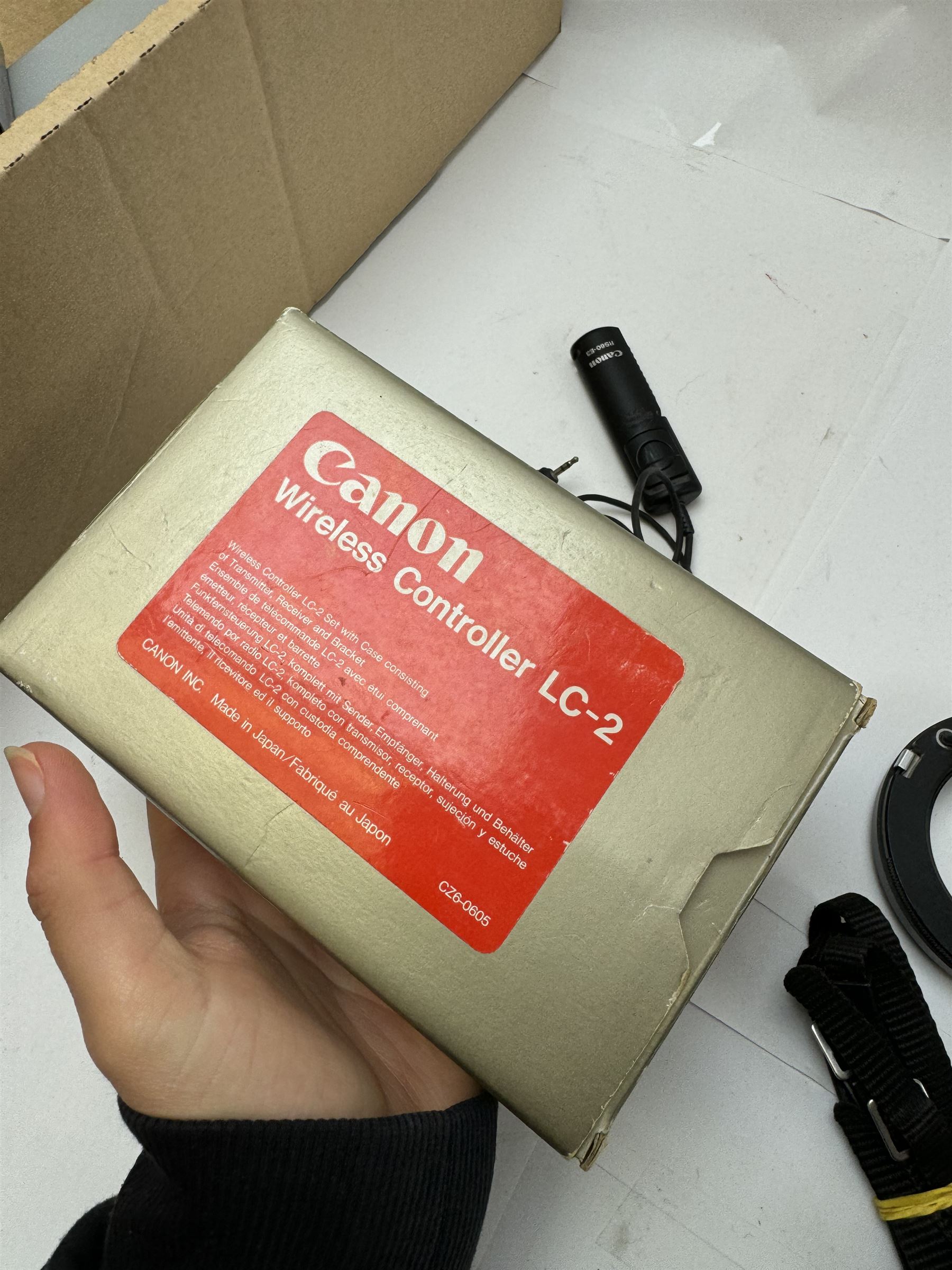 Collection of Canon camera accessories, predominantly for SLR cameras, including flashes, motor drives, quartz date back grips, filters, etc, mostly boxed or cased 