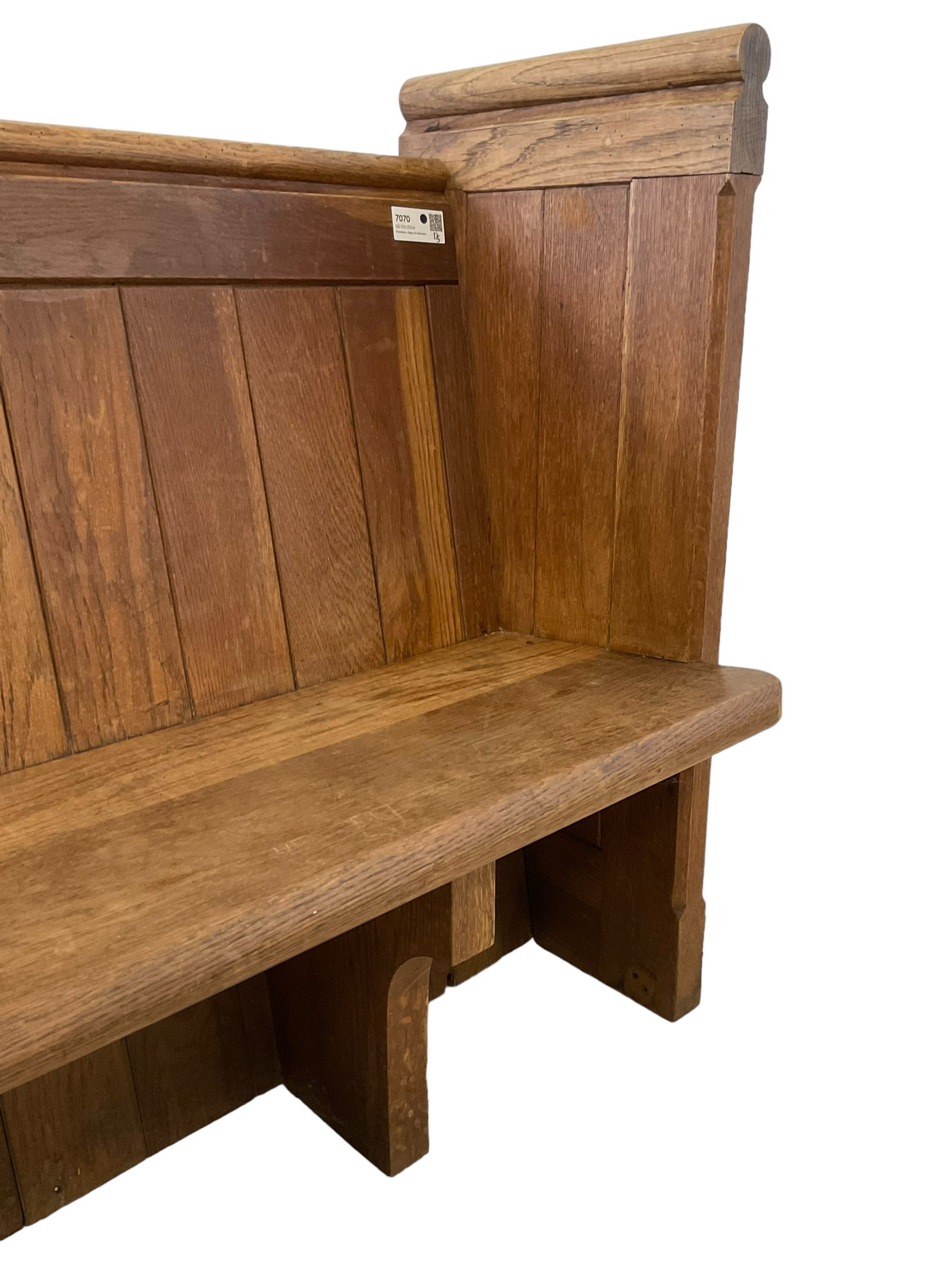 19th century oak church pew or hall bench, moulded cresting rail over panelled back and plank seat, on panelled end supports with chamfered frames