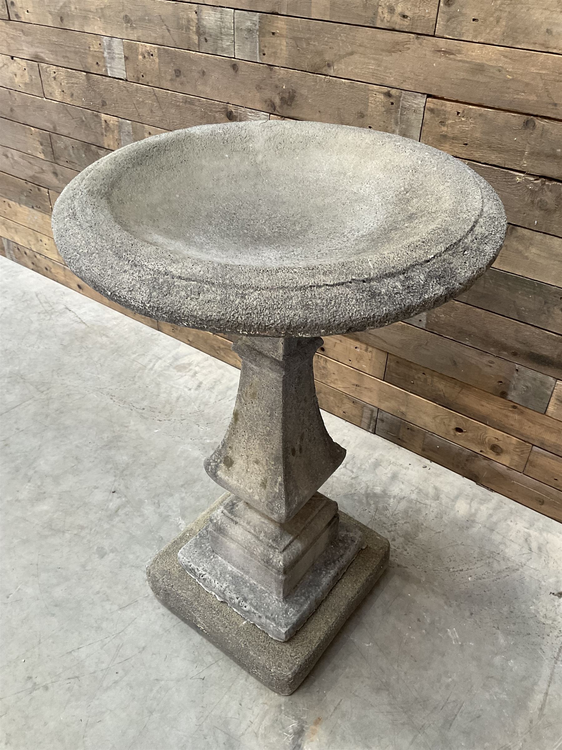 Cast stone garden bird bath, circular dished top, raised on square tapering column, on stepped base with separate mounting plinth